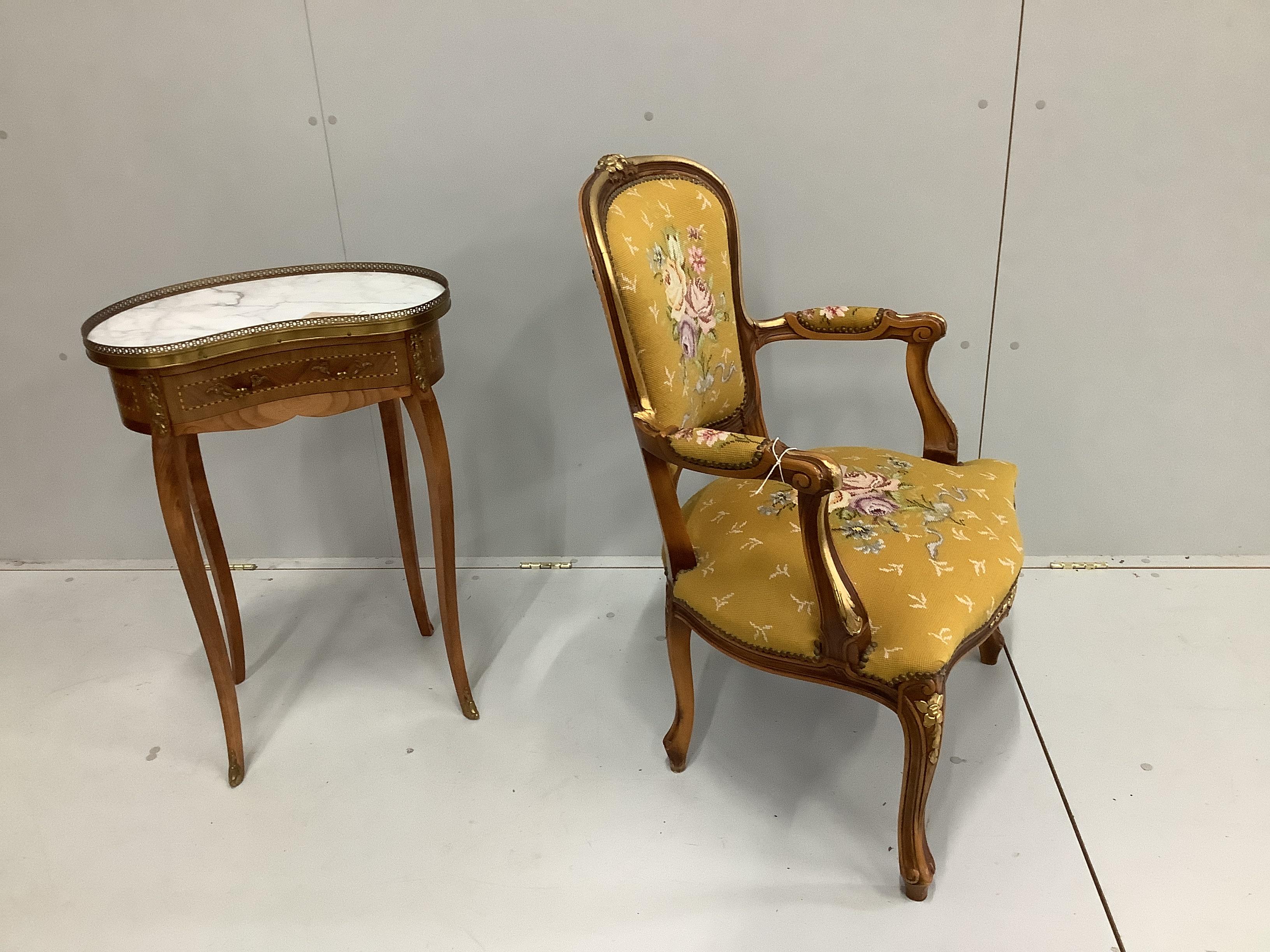 A reproduction Louis XV style gueridon, with inlaid decoration, marble top and gilt metal mounts, width 51cm, depth 32cm, height 74cm together with a Louis XV style fauteuil with floral needlework seat and back